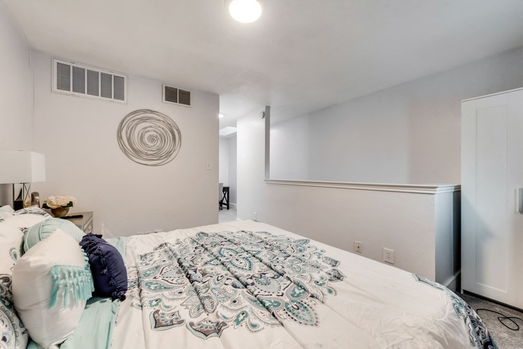 a bedroom with white walls and a large bed