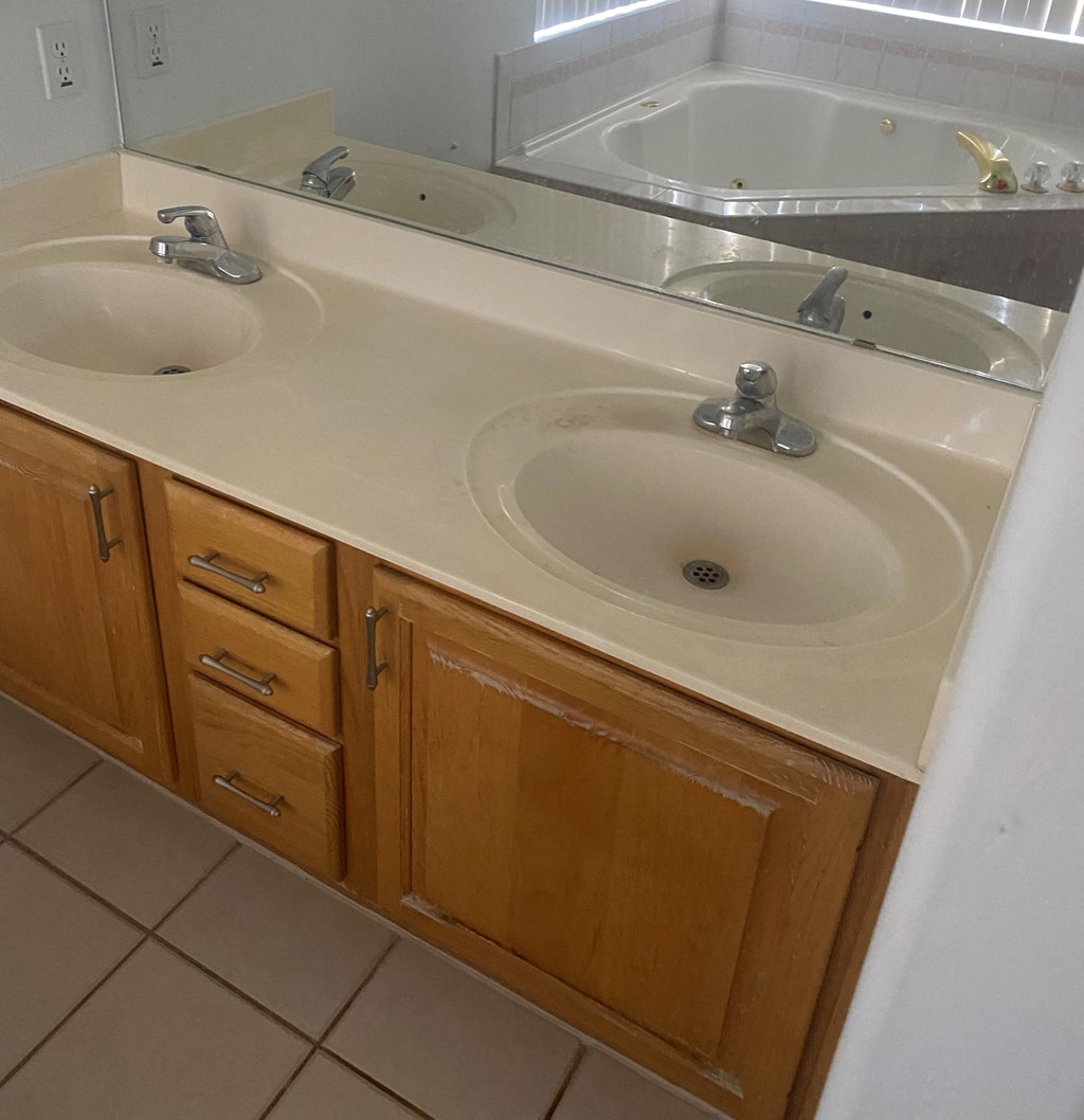 a bathroom with two sinks and a mirror
