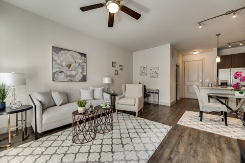 an open living room and dining room with a ceiling fan