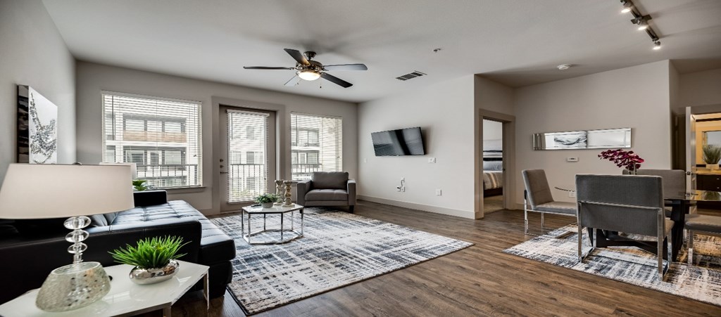 a living room with a couch and a ceiling fan