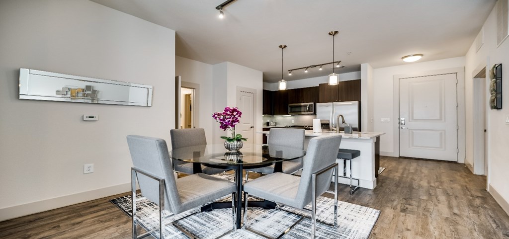 a dining room with a table and chairs and a kitchen