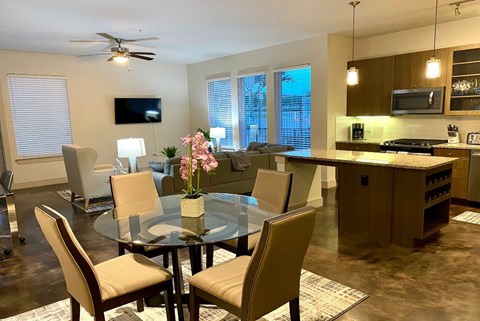 a living room and dining room with a glass table