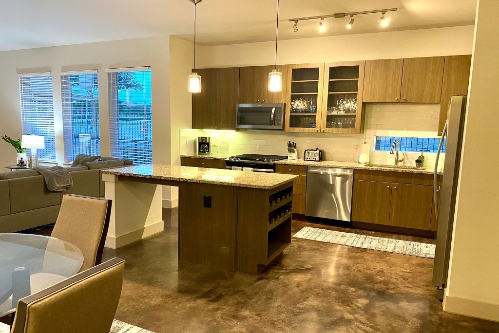 a kitchen and living room with a table and chairs