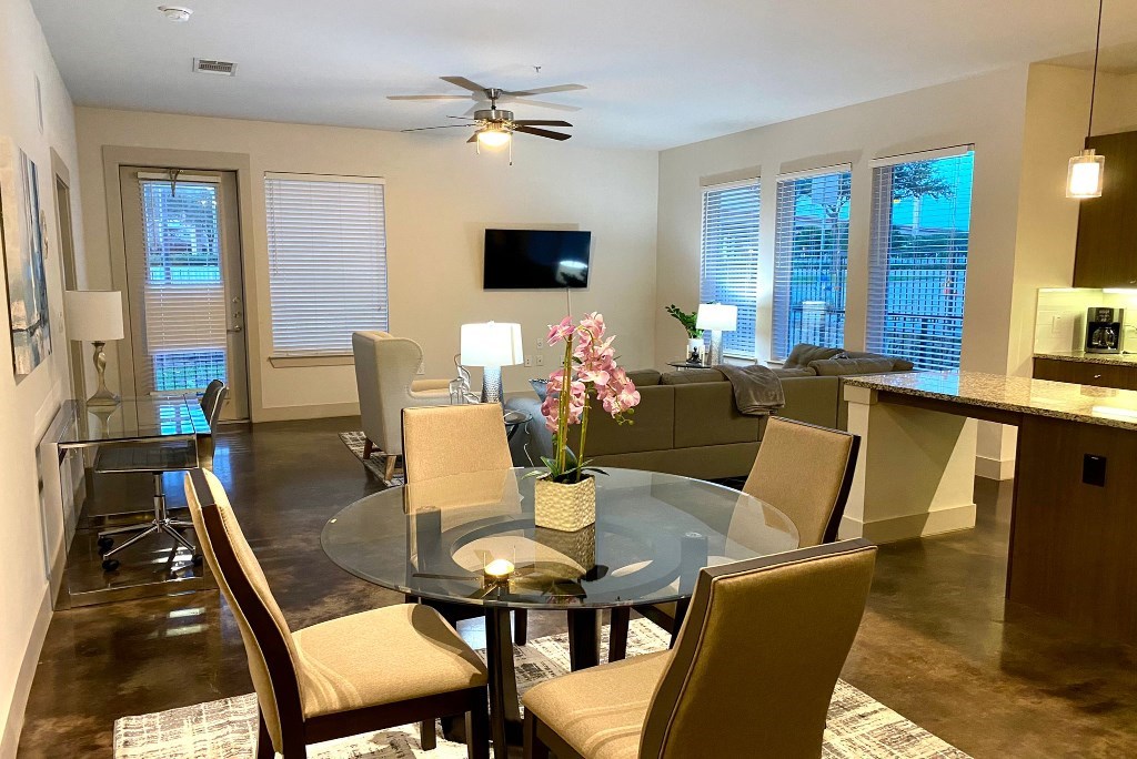 a living room and dining room with a glass table
