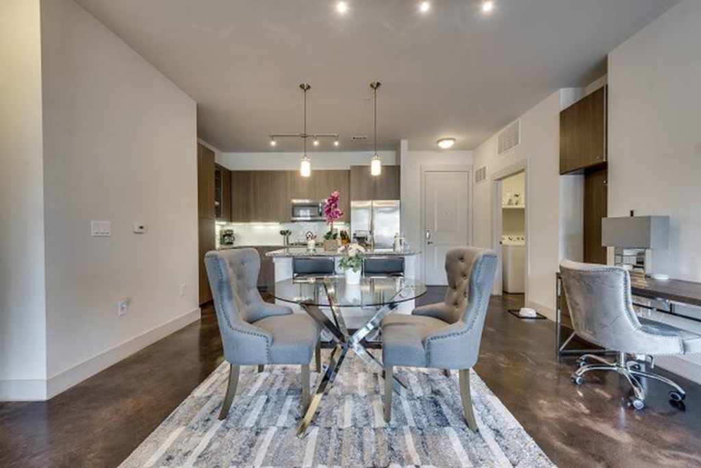 a dining room with a glass table and chairs