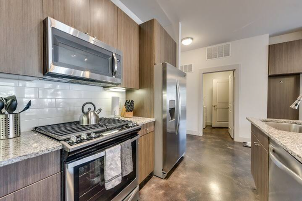 a kitchen with a stove and a refrigerator