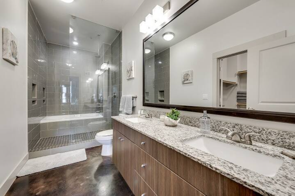 a bathroom with a sink and a shower and a toilet