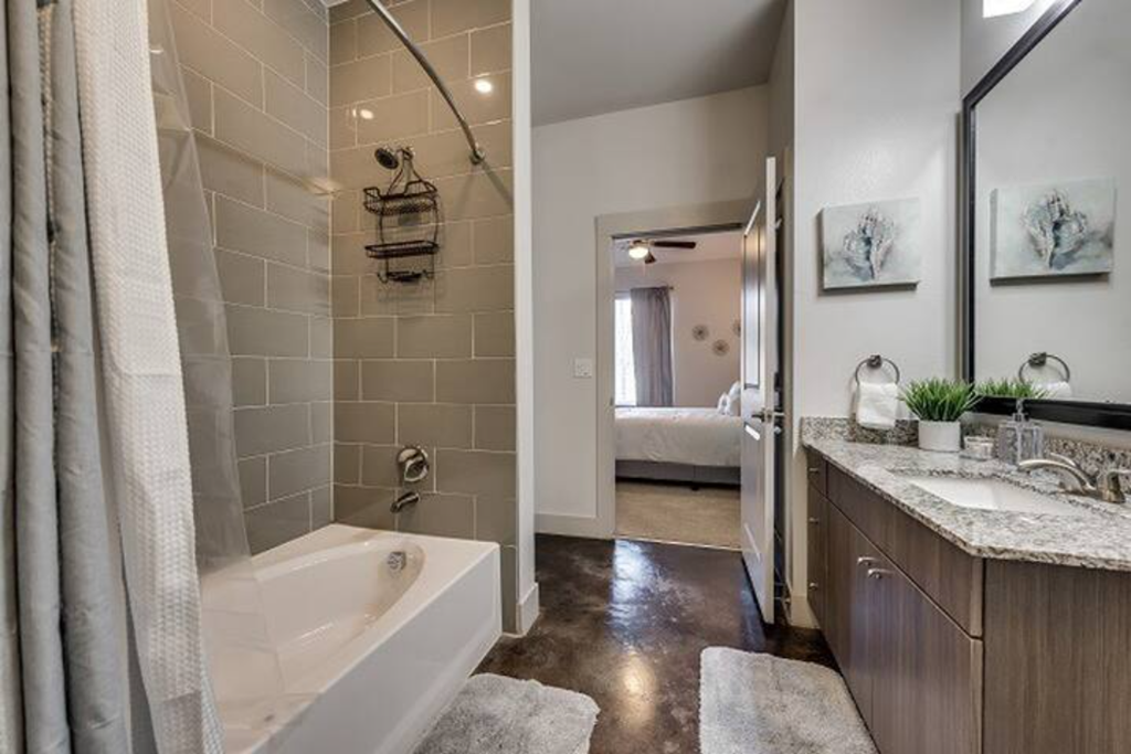a bathroom with a tub and a shower and a sink