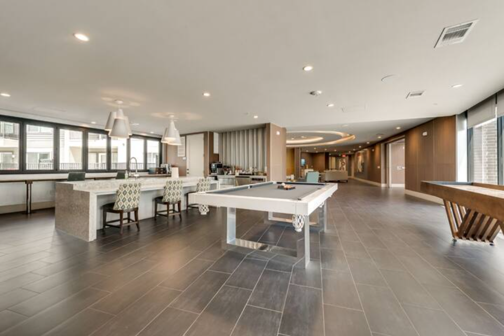 a large room with a pool table in the middle