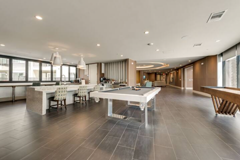 a large room with a pool table in the middle
