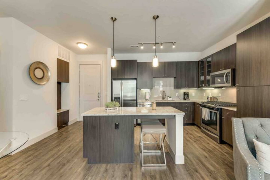 a kitchen with a large island with a white counter top