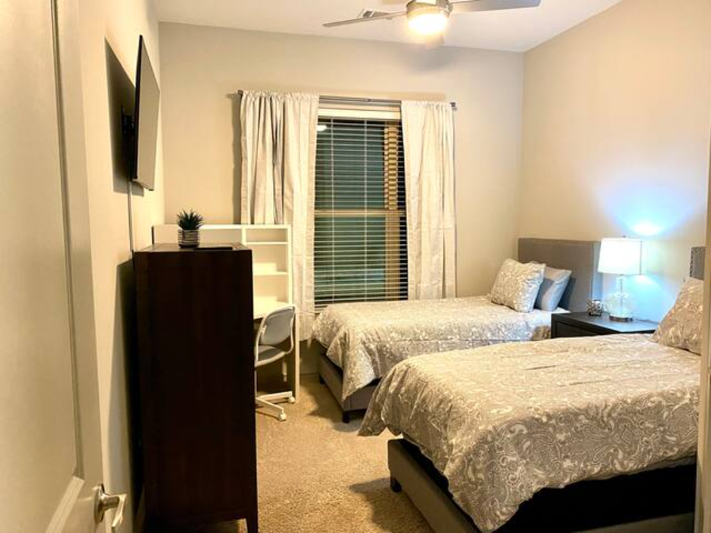 a bedroom with two beds and a tv