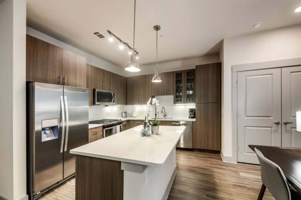 a kitchen with stainless steel appliances and a white counter top