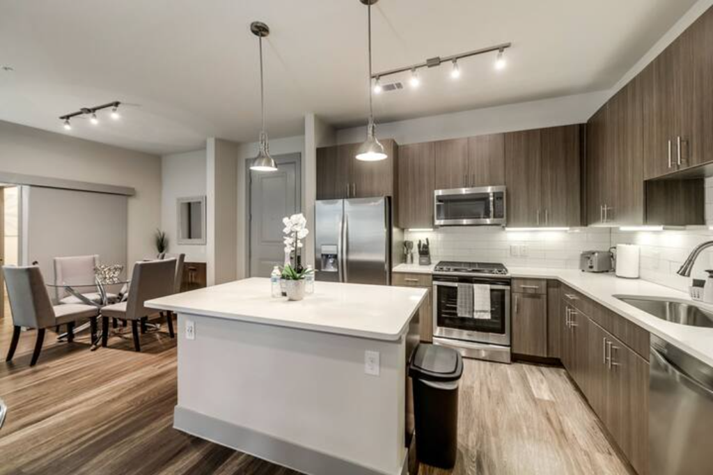 a kitchen and dining room with a white counter top