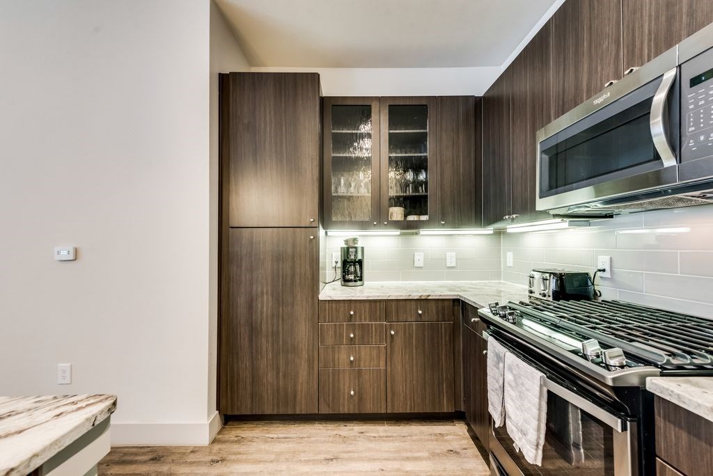 a kitchen with a stove and a microwave