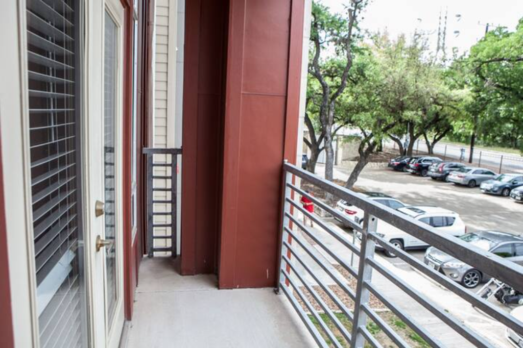 a balcony with a view of a parking lot