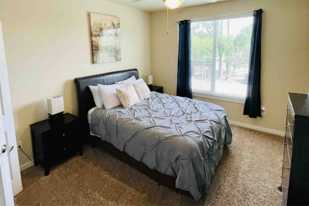 a bedroom with a bed and a window