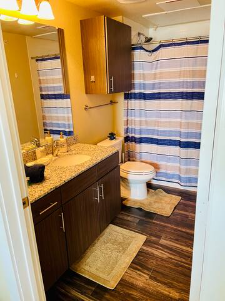 a bathroom with a toilet and a sink and a shower