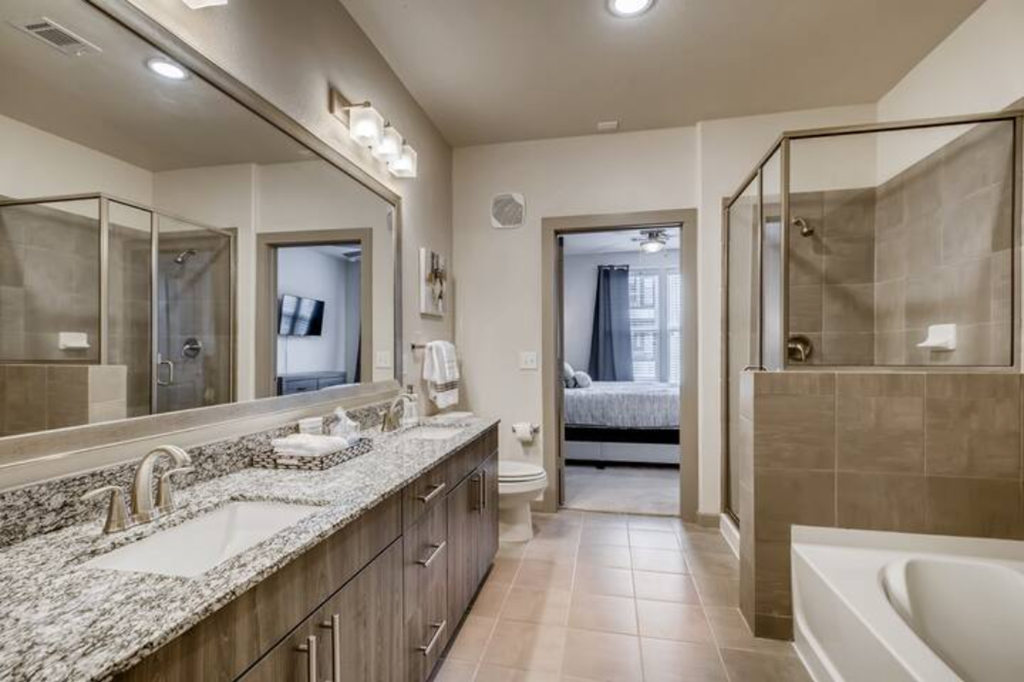 a bathroom with a sink and a mirror and a shower