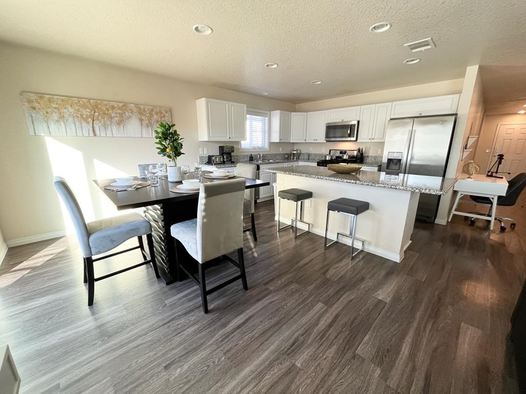 an open kitchen and dining area with a table and chairs