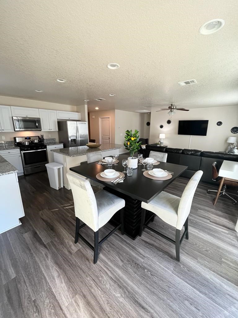 an open kitchen and dining room with a table and chairs