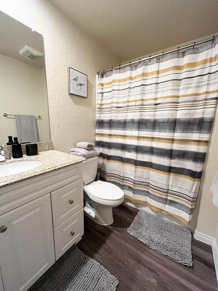 a bathroom with a shower and a toilet and a sink