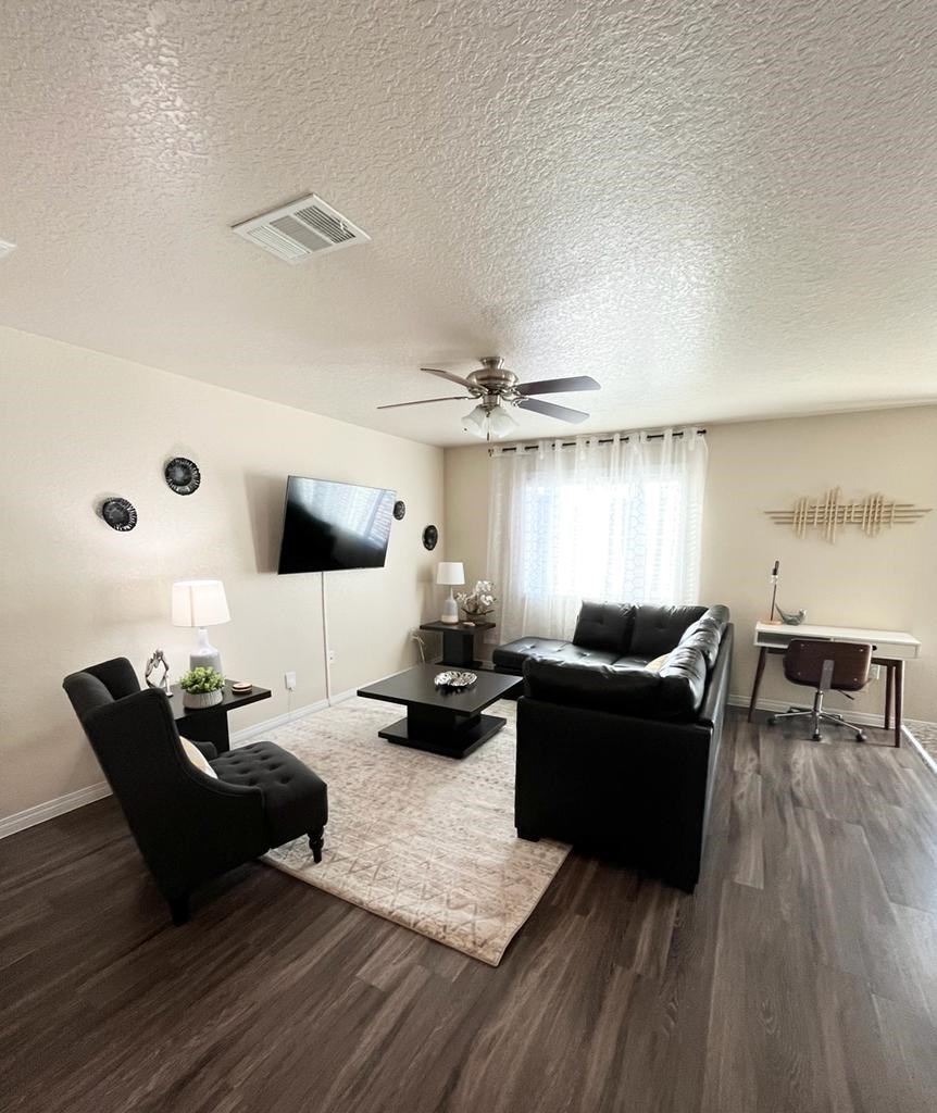 a living room with a couch and a ceiling fan