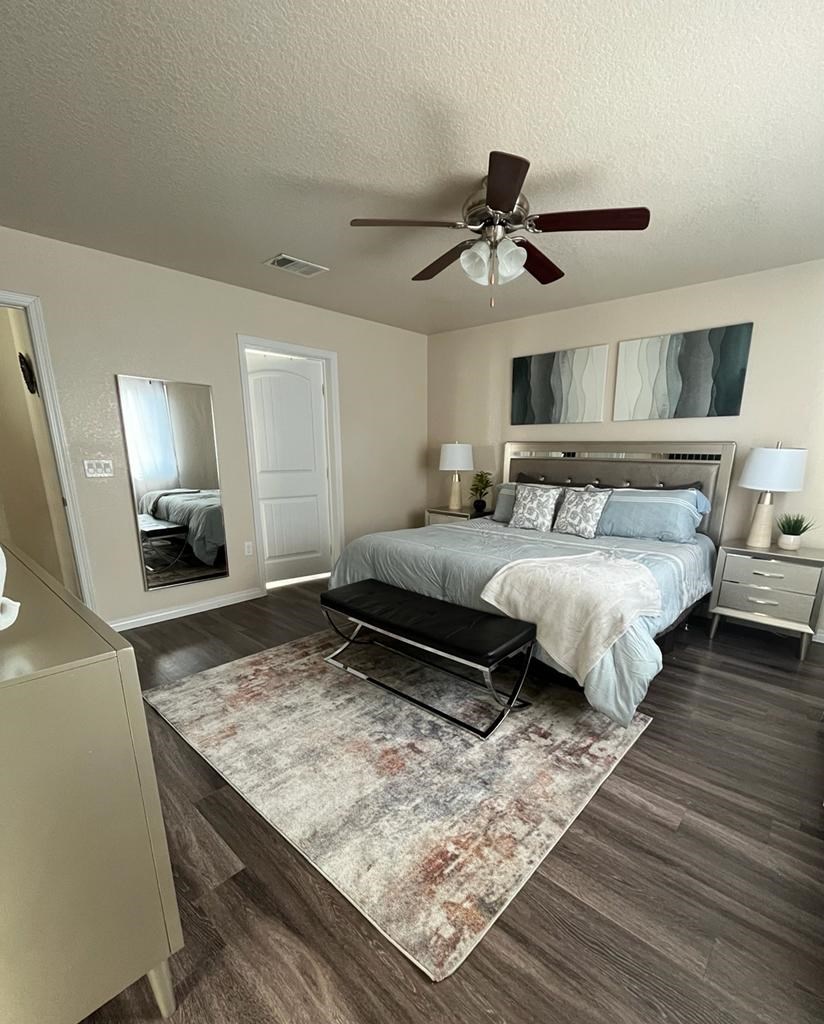 a bedroom with a bed and a ceiling fan