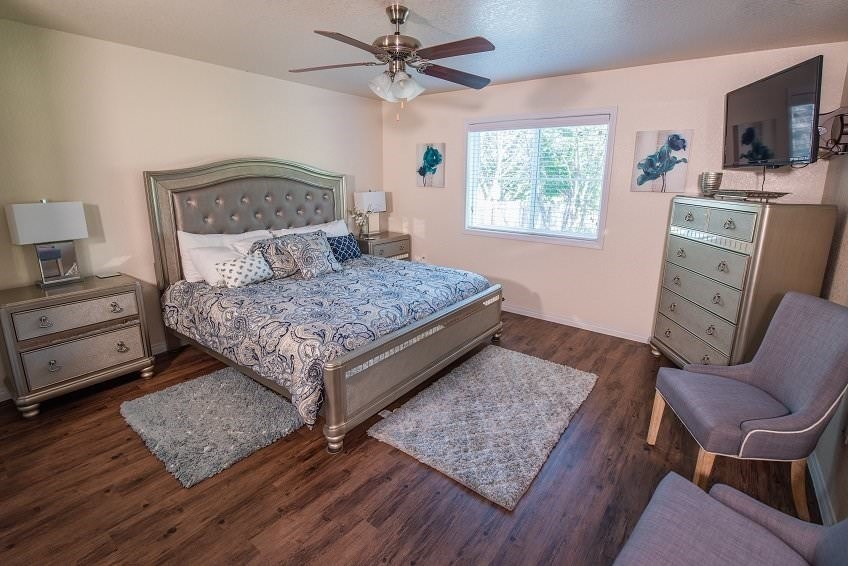 a bedroom with a bed and a ceiling fan
