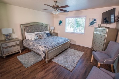 a bedroom with a bed and a ceiling fan