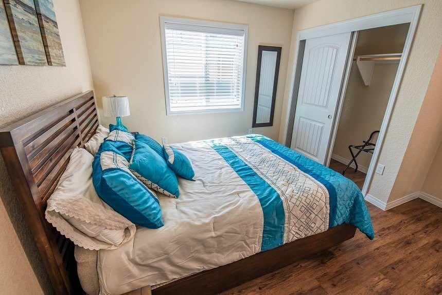 a bedroom with a bed and a window and a closet