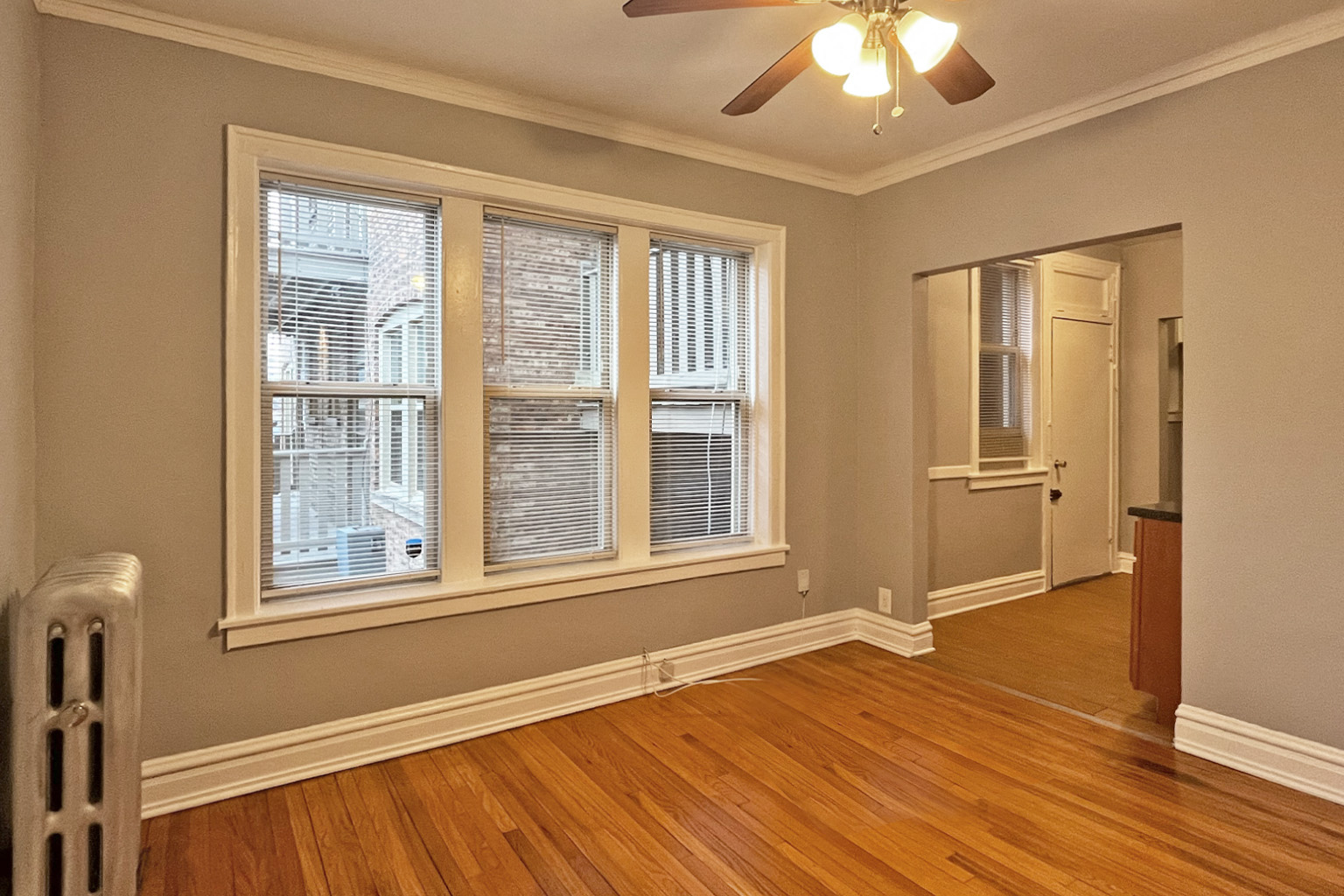 A room with a window and a fan.