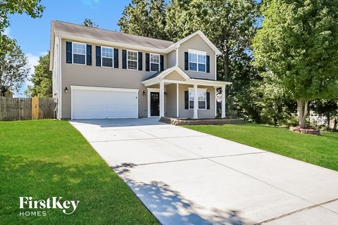 a house with a white driveway in front of it