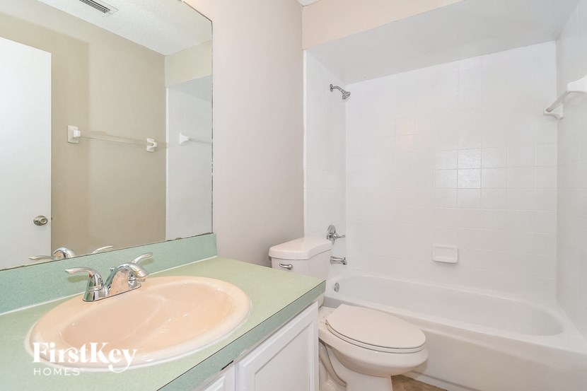 a white bathroom with a sink and a toilet