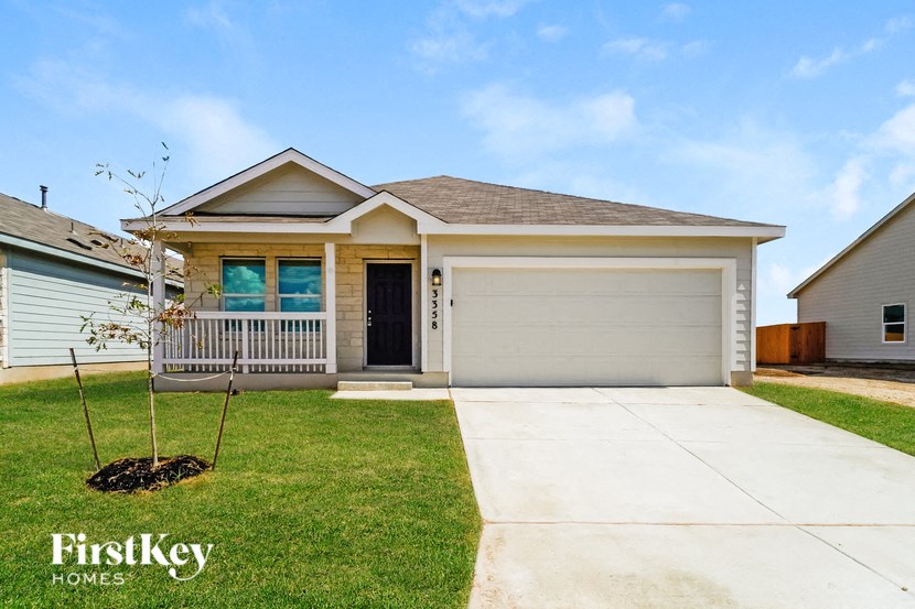 a home with a lawn and a sidewalk in front of it