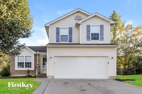 A two-story house with a garage is for sale.