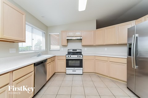 a kitchen with wooden cabinets and stainless steel appliances