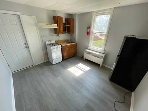 A small room with a washing machine and a window.