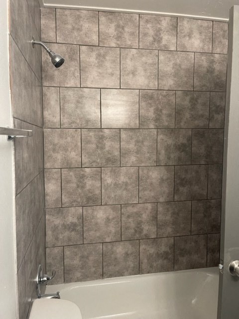 a small bathroom with a shower and a toilet