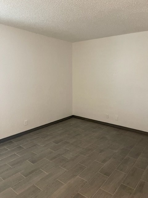 an empty room with a tile floor and white walls