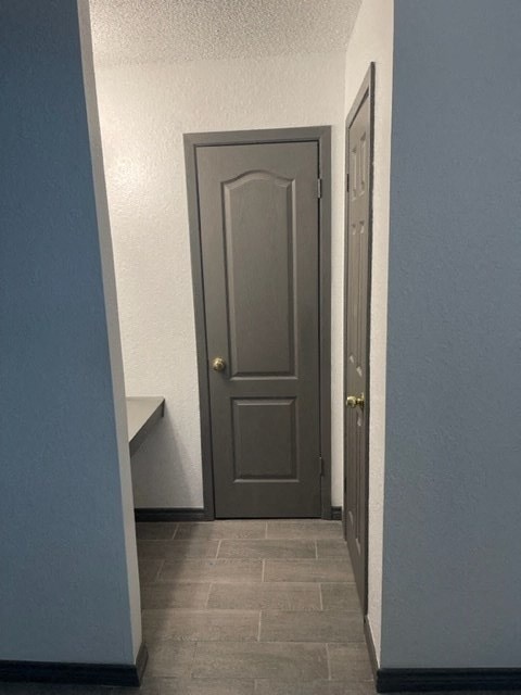 a hallway with a door and a blue wall