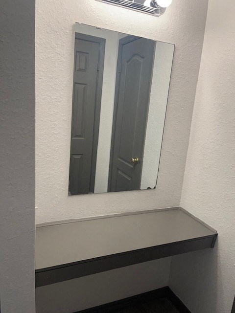 a bathroom with a mirror and a bench