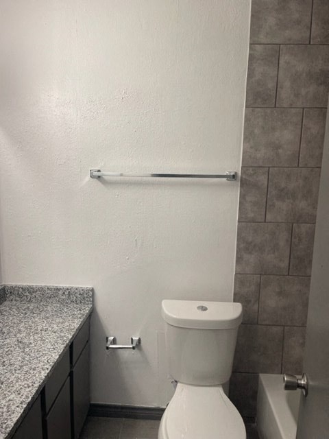 a bathroom with a toilet and a towel rack