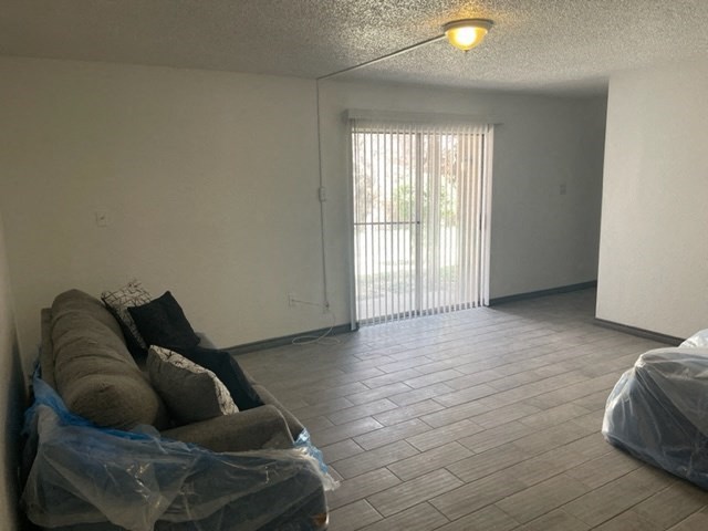 a living room with a couch and a sliding glass door