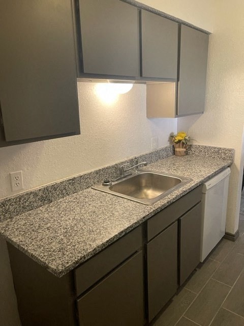 a kitchen with a sink and a counter top