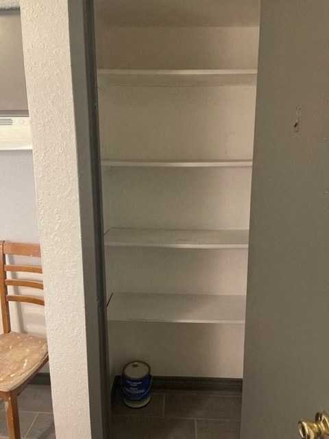 a empty shelf in a room with a chair
