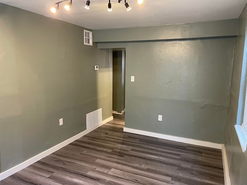 a living room with gray walls and a wooden floor