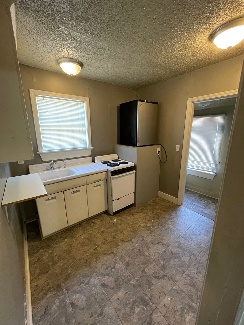 a kitchen with a sink and a refrigerator
