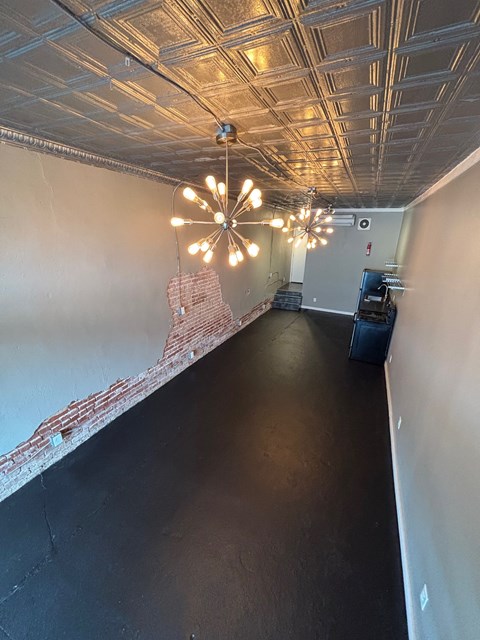 A long hallway with lights on the ceiling.