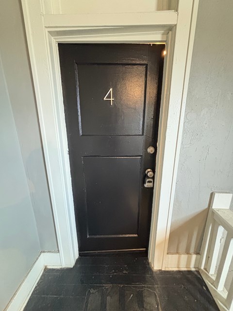 A black door with the number 4 on it.